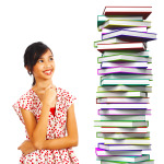 Young Student Smiling At Books To Read